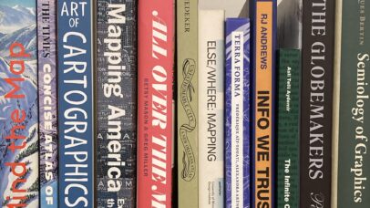A photo of some cartography books on a shelf